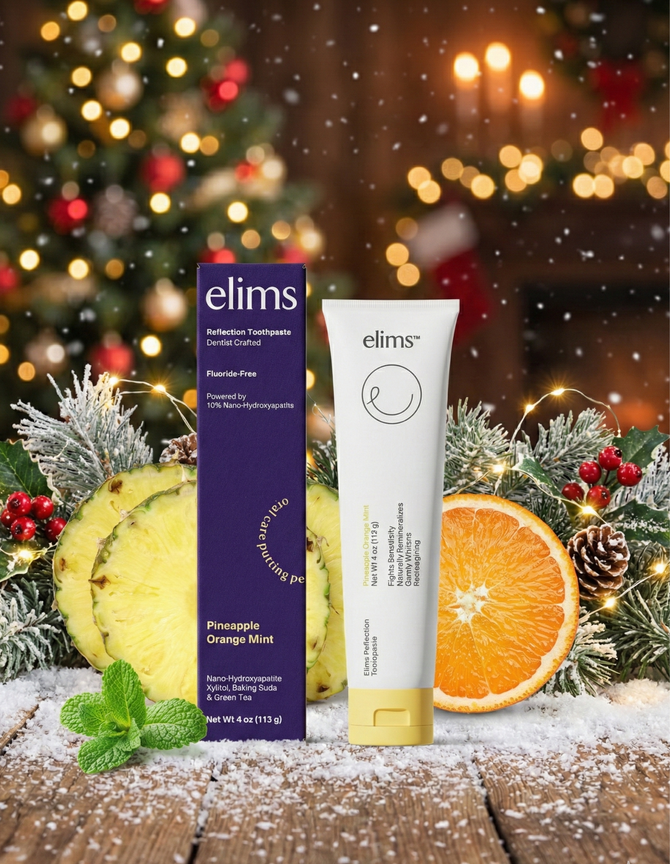 Elims pineapple orange mint toothpaste with packaging on a festive background with Christmas decorations.