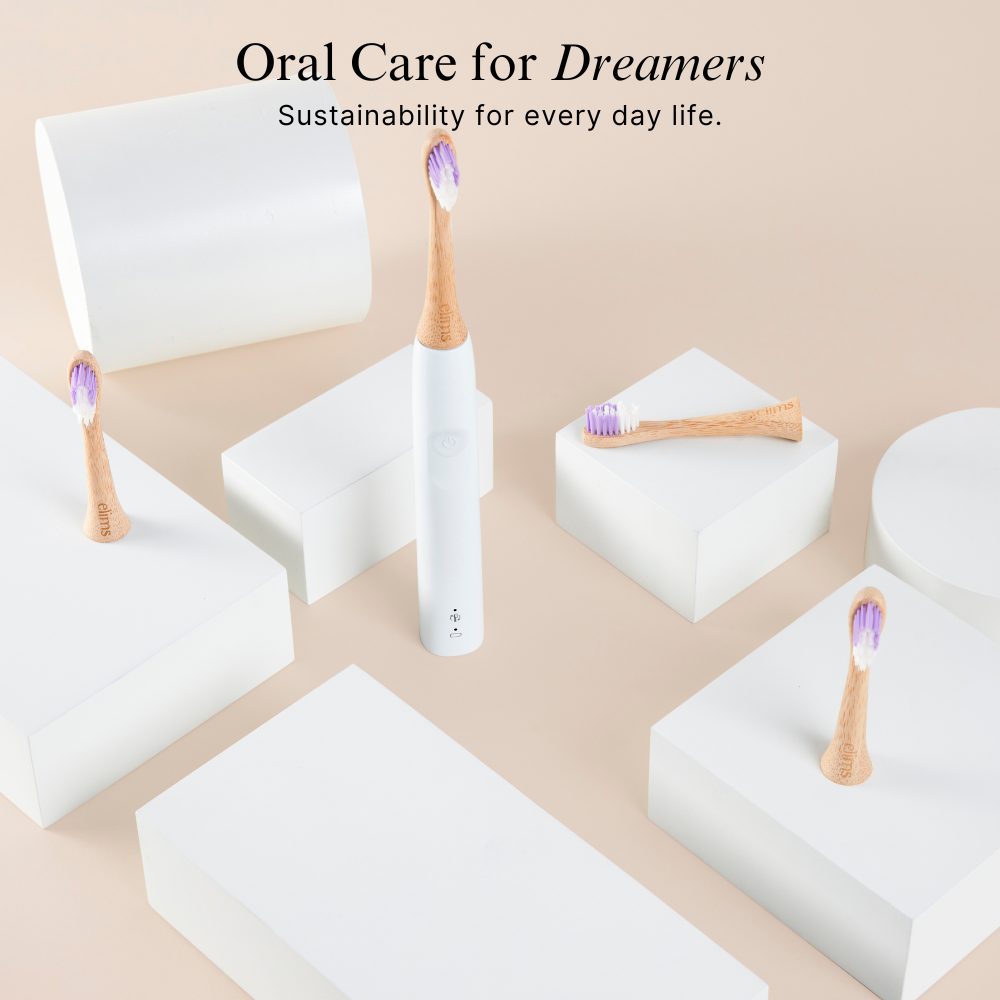 Sustainable eco-friendly bamboo oral care products with  plastic free sonicare toothbrushes and containers on a beige background.