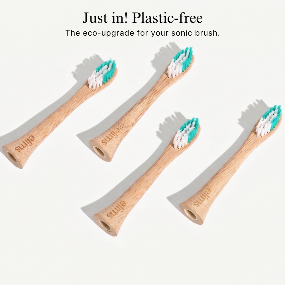 Four elims eco-friendly and sustainable and plastic free bamboo toothbrushes with castor oil bristles on a white background.