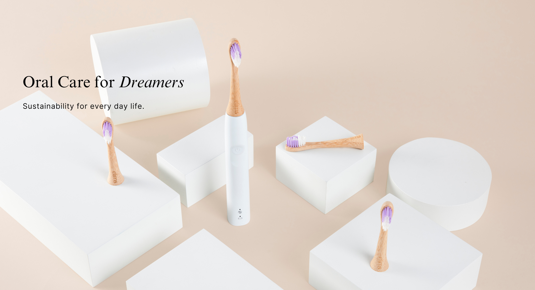 Sustainable eco-friendly bamboo oral care products with  plastic free sonicare toothbrushes and containers on a beige background.