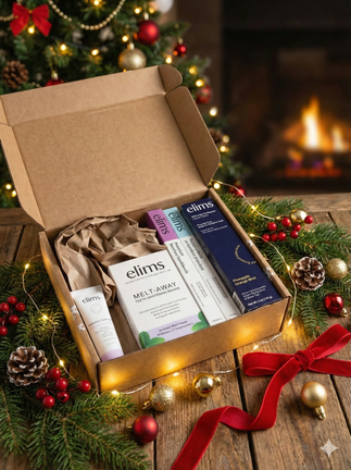 image of elims products laid out in a neat line on a wood table with pine cones and elims gift box behind it