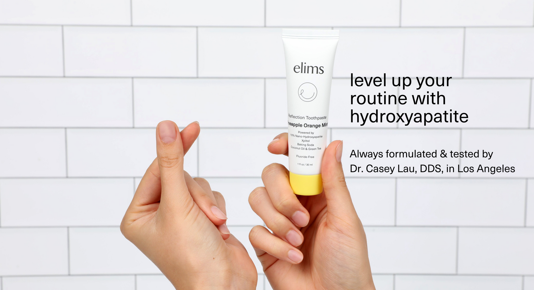 travel size toothpaste held by hands